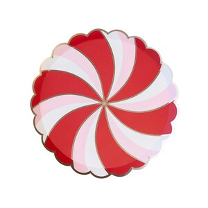 May include: Red and white swirl patterned paper plates with a gold trim. The plates have a scalloped edge.