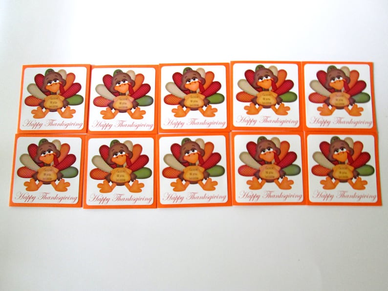 May include: A collection of ten Thanksgiving-themed square cards. Each card features a cartoon turkey with colorful feathers and the text "Happy Thanksgiving". The cards have an orange border and a white background.