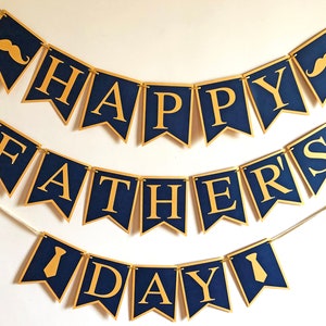 May include: A navy blue banner set with gold lettering and accents, spelling out "HAPPY FATHER'S DAY." The banner includes mustache and tie graphics. Perfect for Father's Day celebrations.
