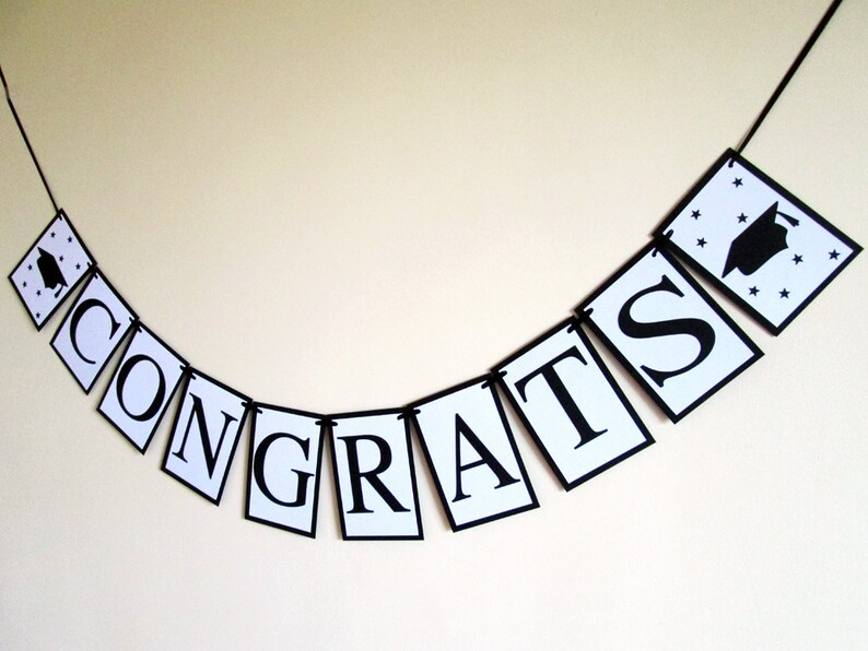 May include: Black and white graduation banner with the word "CONGRATS" and a graduation cap icon.