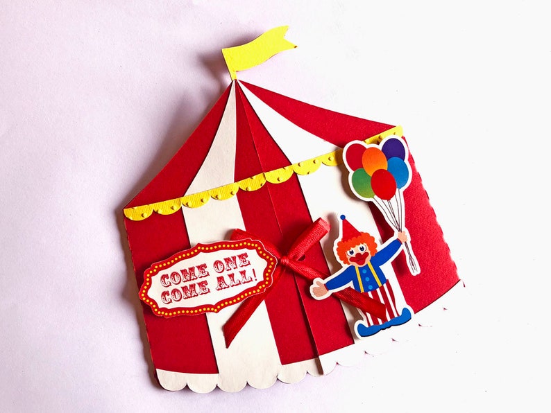 Puede incluir: Invitaci&oacute;n de circo en forma de carpa roja y blanca con una bandera amarilla en la parte superior. La carpa tiene un borde festoneado y un cartel que dice "&iexcl;Venid todos!" Un payaso con el pelo rojo y un traje azul y rojo sostiene un ramo de globos de colores.