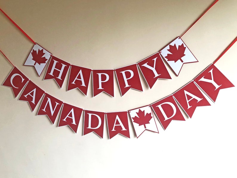 May include: Red and white banner with the text "Happy Canada Day" in white letters. The banner has maple leaf cutouts.