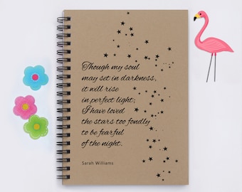 May include: A brown notebook with a spiral binding features a quote about loving the stars. The quote reads "Though my soul may set in darkness, it will rise in perfect light; I have loved the stars too fondly to be fearful of the night." The quote is attributed to Sarah Williams. The notebook is decorated with black stars.