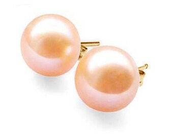 May include: A pair of round, blush-colored pearl stud earrings with gold posts. The pearls have a smooth, lustrous surface, reflecting light. The earrings are set against a white background, highlighting their elegant simplicity.