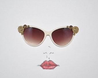 Golden sun Designer fashion embellished cream and tortoise cat-eye sunglasses.