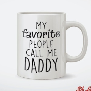 May include: White ceramic coffee mug with black text that reads "My favorite people call me Daddy".