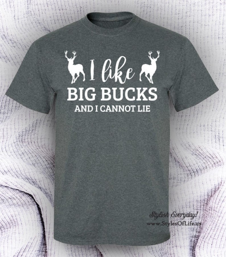 May include: A dark gray t-shirt with a white graphic of two deer and the text "I like BIG BUCKS AND I CANNOT LIE".