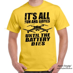 May include: Yellow t-shirt with black text that reads "It's all fun and games until the battery dies." A black silhouette of a drone is above the text.