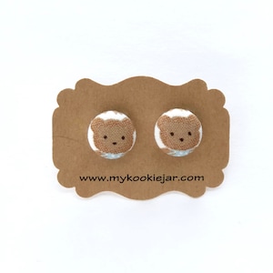 May include: A pair of brown bear stud earrings on a brown card with the text "www.mycookiejar.com".