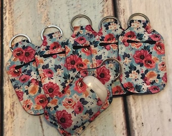 Blue FLORAL Print HAND SANITIZER Holder Key Chain Air Pod Case - Quantity One
