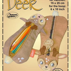 May include: A brown pencil case with a deer design. The case is open and has pencils inside. The case is 6 inches by 10 inches and is for a 15 inch by 25 inch hoop.