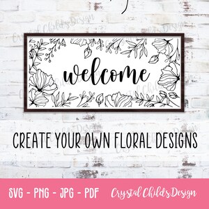 May include: A black and white welcome sign with a floral border. The sign is framed in a black frame and has the word "welcome" written in a cursive font.