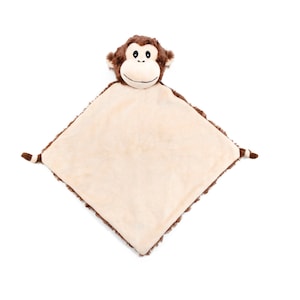 Puede incluir: Una manta de seguridad de mono de peluche marrón y beige. La cara del mono está cosida en la manta y tiene ojos negros y una nariz negra.