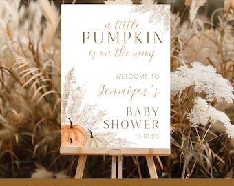 May include: A custom-printed baby shower sign on an easel. The sign features the text "a little PUMPKIN is on the way" and "Welcome to Jennifer's BABY SHOWER 10.10.25". The sign has a pumpkin and floral design.