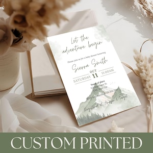 May include: A white baby shower invitation with the text "Let the adventure begin" and details for Sierra Smith's baby shower. The invitation features a mountain landscape design and the words "Custom Printed" at the bottom.