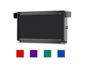 May include: Black ink cartridge for a stamp. The cartridge is rectangular and has a black rubber pad. The cartridge is shown against a white background.