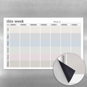 May include: A white magnetic weekly planner with the text "this week" at the top. The planner has columns for each day of the week and rows for family members and dinner. The color-coded sections are in pastel shades.
