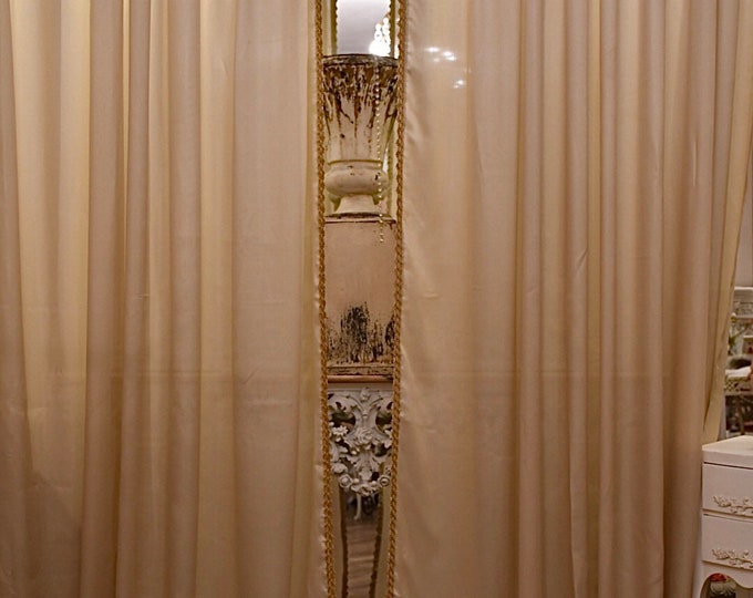 Pair of pale gold lurex curtains with braid trimmings