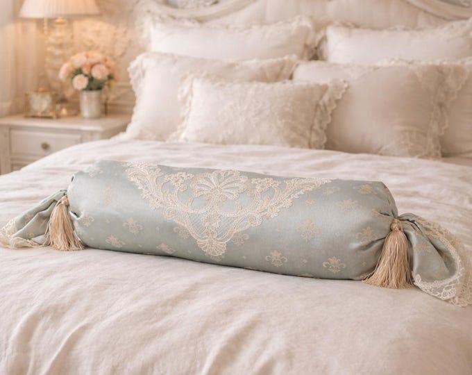 Luxury cylindrical cushion in light blue satin and fine lace from the “Royal Stile” collection.
