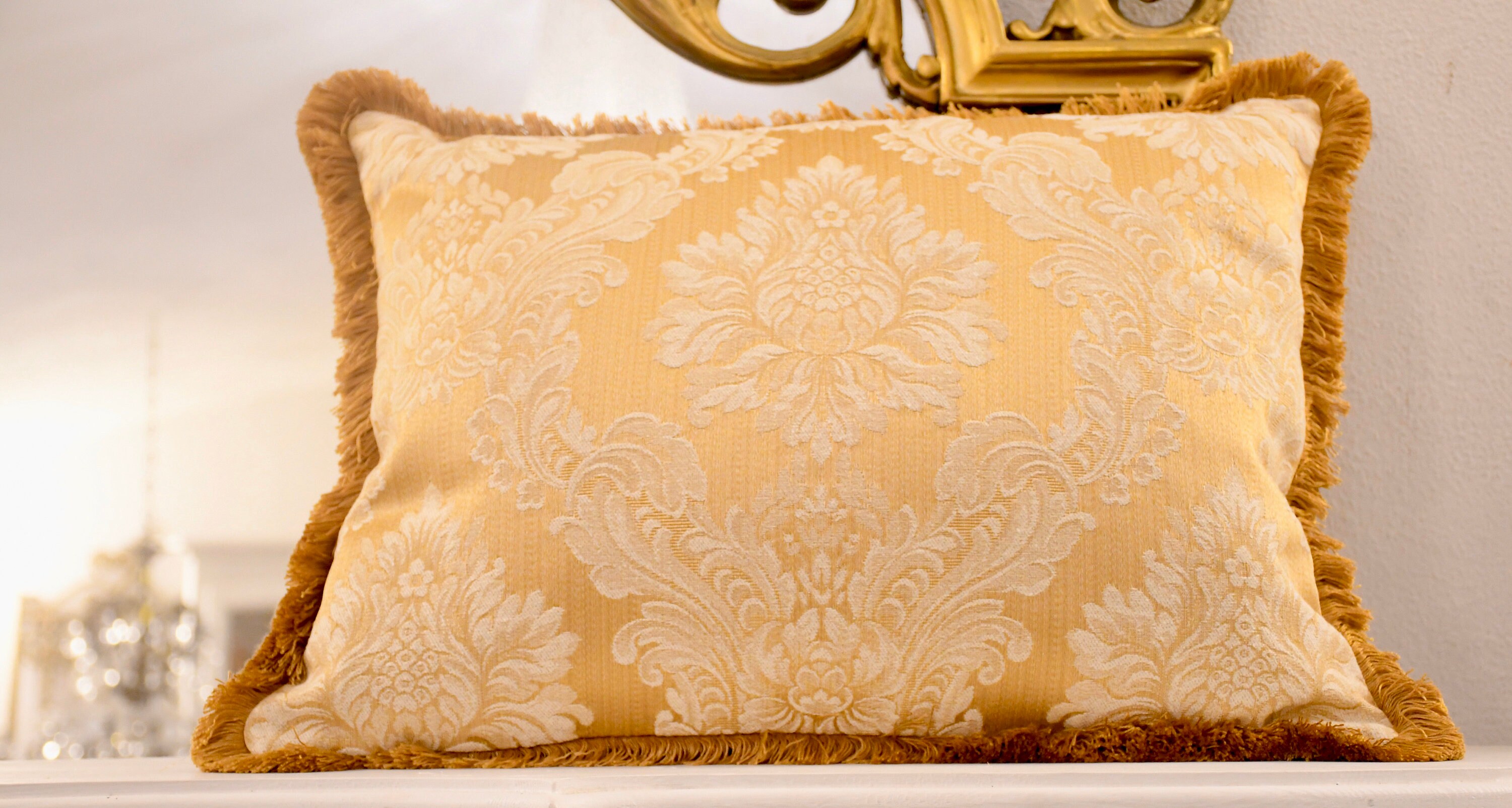 Gold damask cushion and fine trimema