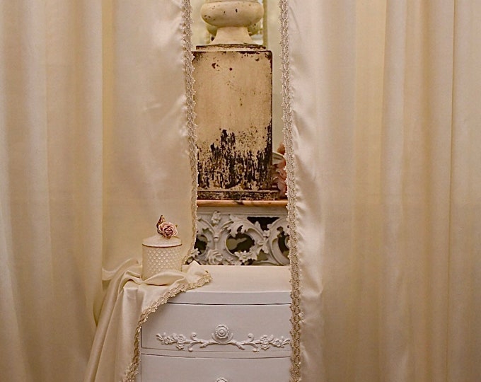 Pair of pearl ivory lurex curtains with braid trimmings