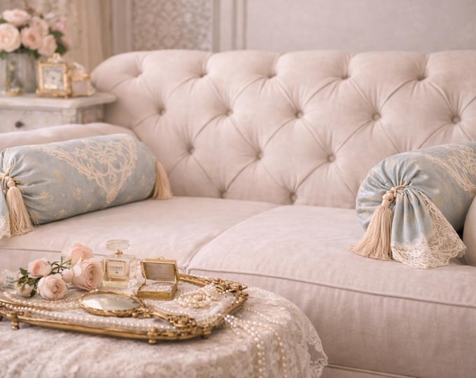 Luxury cylindrical cushion in light blue satin and fine lace from the “Royal Stile” collection.