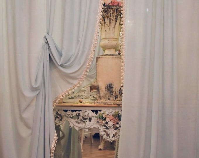 Pair of curtains in pure Italian georgette in powder blue with precious trimmings