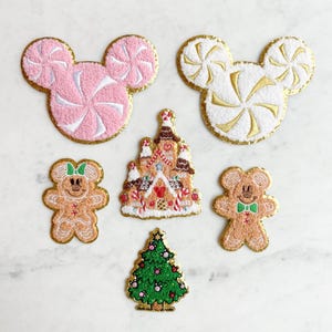 May include: Five embroidered iron-on patches featuring a gingerbread house, a Christmas tree, two gingerbread mice, and two candy cane Mickey Mouse heads.