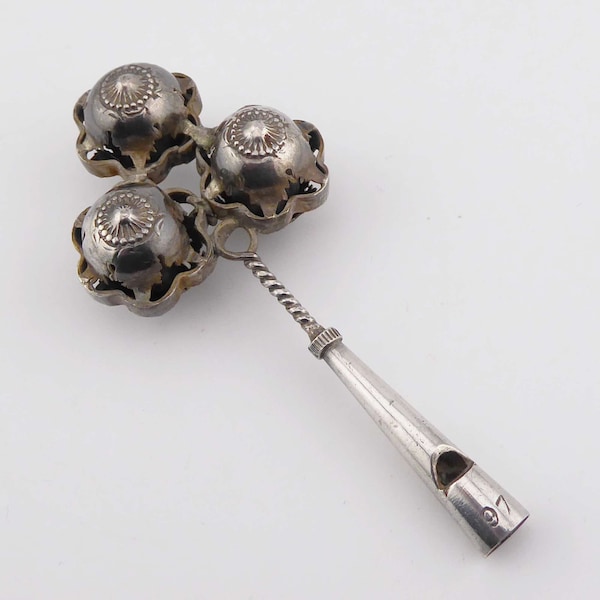 A vintage Silver Baby's Rattle with Whistle handle