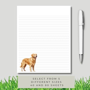 May include: A lined notepad with a golden retriever illustration at the bottom. A white pen rests beside the notepad. The notepad has the text "SELECT FROM 5 DIFFERENT SIZES 40 AND 80 SHEETS".