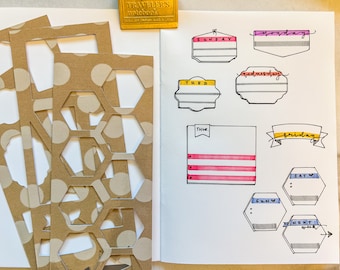 May include: A notebook spread with cut-out paper shapes and hand-drawn weekly planner elements. The planner includes labeled banners for each day of the week, with colors like pink, yellow, and blue. The cut-out shapes are brown with white polka dots.