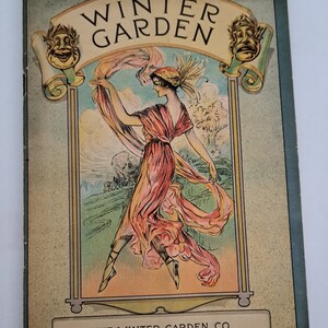 May include: A vintage illustration of a woman in a pink dress dancing in a field. The illustration is surrounded by a decorative frame with the text "Winter Garden" and "The Winter Garden Co. Lessees and Managers".