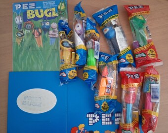 8 Vintage BUGZ PEZ in BAGS & Counter Top Box (empty) and header