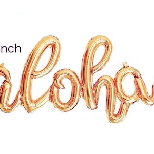 May include: Gold foil balloon spelling "Aloha" in a cursive font. The balloon is 45 inches long.