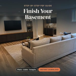 May include: A digital guide titled STEP-BY-STEP PDF GUIDE Finish Your Basement, featuring a living room with a large beige sofa, a television mounted on a wall unit, and a kitchen area in the background. Includes buttons for Plans, codes, budgets and INSTANT DOWNLOAD.