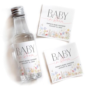 May include: Baby shower favor labels with a floral design and the text "Baby in Bloom" with the name Emma and the date August 12, 20XX.