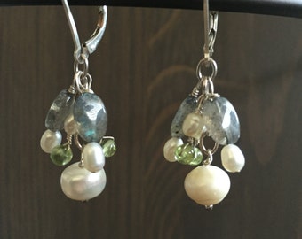May include: Silver dangle earrings with a cluster of blue, green, and white stones. The stones are arranged in a cascading design.