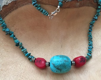 May include: A turquoise and red beaded necklace with a large turquoise focal bead and silver accents.