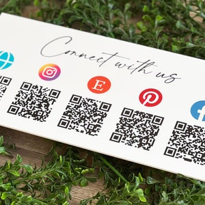 May include: White card with the text "Connect with us" and five QR codes. Each QR code is accompanied by a social media icon: a globe, Instagram, Etsy, Pinterest, and Facebook.