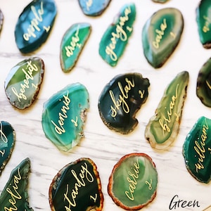 May include: Green agate slices with gold calligraphy names, such as "apple", "benedict", "drew", "dennis", "skylar", "carrie", "brian", "william", "georgina", "cara", and "stanley".