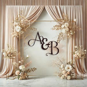 May include: A wedding backdrop with a gold geometric frame and white flowers. The letters "A & B" are displayed in a black script font.