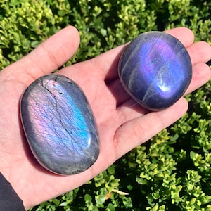 Purple labradorite palm stone with imperfections, tiny chip