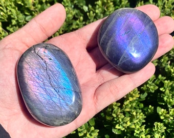 Purple labradorite palm stone with imperfections, tiny chip