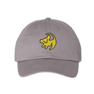 May include: A gray baseball cap with a yellow embroidered lion king logo.