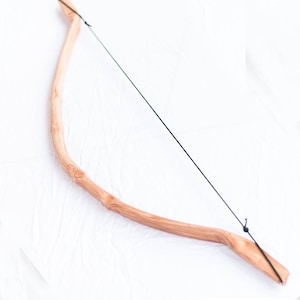 May include: A wooden bow with a black string, made by PVC Armory.