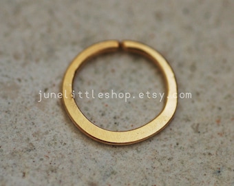 May include: A gold-colored metal hoop earring. The hoop is thick and has a smooth, polished finish.