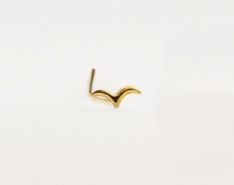 May include: A gold nose ring with a simple bird design.