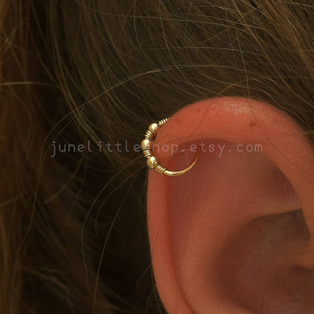 How are people “doing” hoops in helix piercings? Especially for