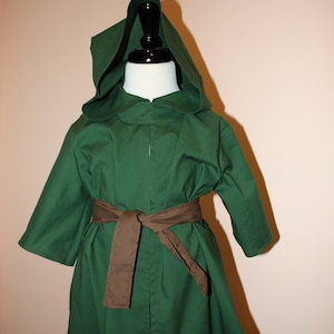 May include: A green hooded cloak with a brown belt. The cloak is made of a soft, comfortable fabric and has a relaxed fit.