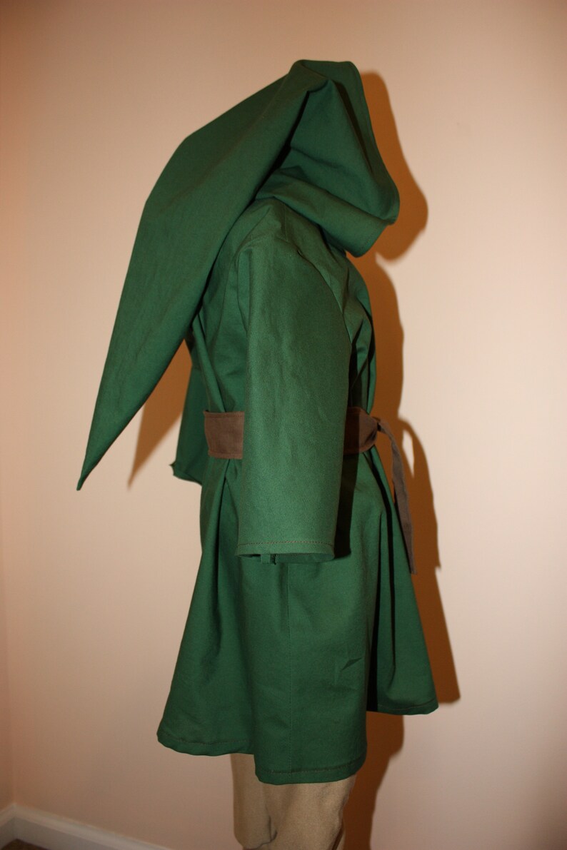 May include: A green hooded cloak with a brown belt. The cloak is made of a thick fabric and has a long, flowing hood.